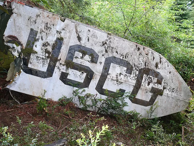 After finding the U.S. Coast Guard Helicopter that crashed during a rescue effort, killing all seven aboard, members of the search party signed a piece of the wreckage. - PHOTO COURTESY OF GREG RUMNEY