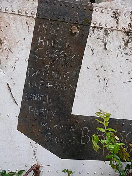 After finding the U.S. Coast Guard Helicopter that crashed during a rescue effort, killing all seven aboard, members of the search party signed a piece of the wreckage. - PHOTO COURTESY OF GREG RUMNEY