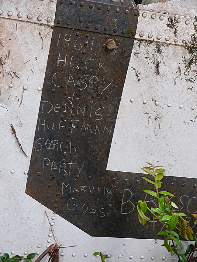 After finding the U.S. Coast Guard Helicopter that crashed during a rescue effort, killing all seven aboard, members of the search party signed a piece of the wreckage. - PHOTO COURTESY OF GREG RUMNEY