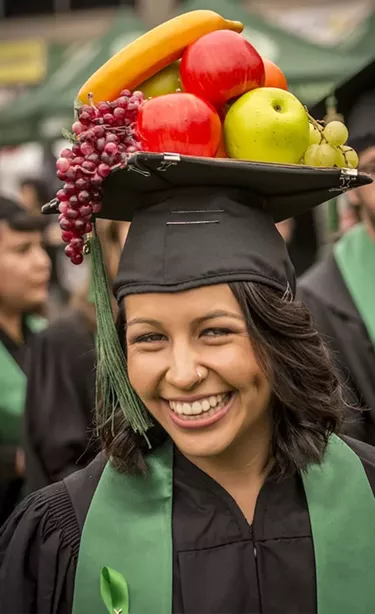 Communication major Ana Luisa Chavez wore her Carmen Miranda-like fruit-laden mortarboard hat. - MARK LARSON