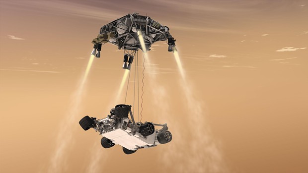 Curiosity's "sky crane" system. The spacecraft's descent stage lowers the rover on a bridle prior to touchdown in Gale Crater, five degrees south of the Martian equator. - COURTESY OF NASA