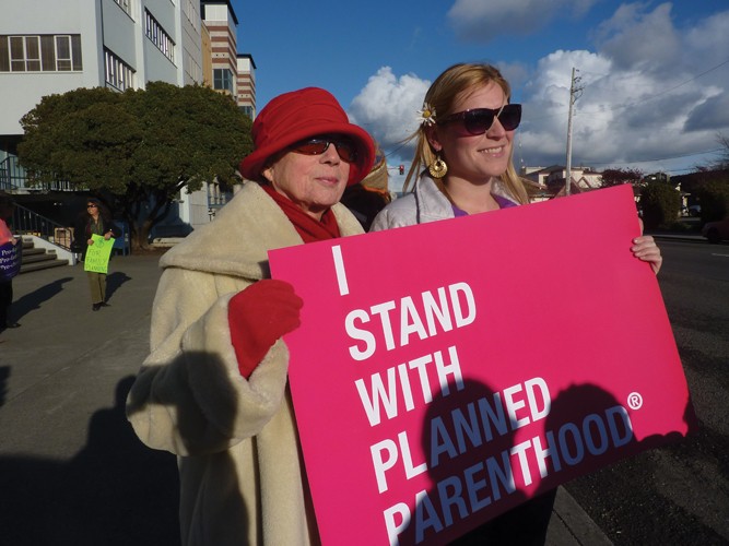 Ellen Bryant (left) and Beth Werner were among an estimated 200 persons who turned out at the behest of Six Rivers Planned Parenthood to protest budget cuts that could trim funds representing about 3.5 percent of the organization's total budget