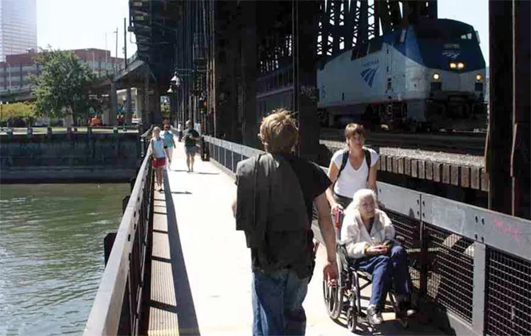 In Portland, Ore., a bike and pedestrian trail is attached to the railroad bridge. - FROM THE 2012 “HUMBOLDT BAY RAIL-WITH-TRAIL” REPORT BY GHD OF EUREKA (FORMERLY WINZLER & KELLY).