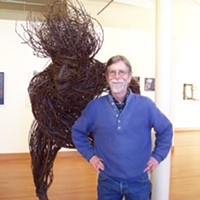 Jack Sewell with his plum twig sculpture "Transplantation."