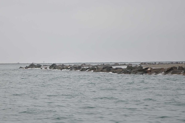 Water pushes over the jetty wall onto the north spit beach. - GRANT SCOTT-GOFORTH