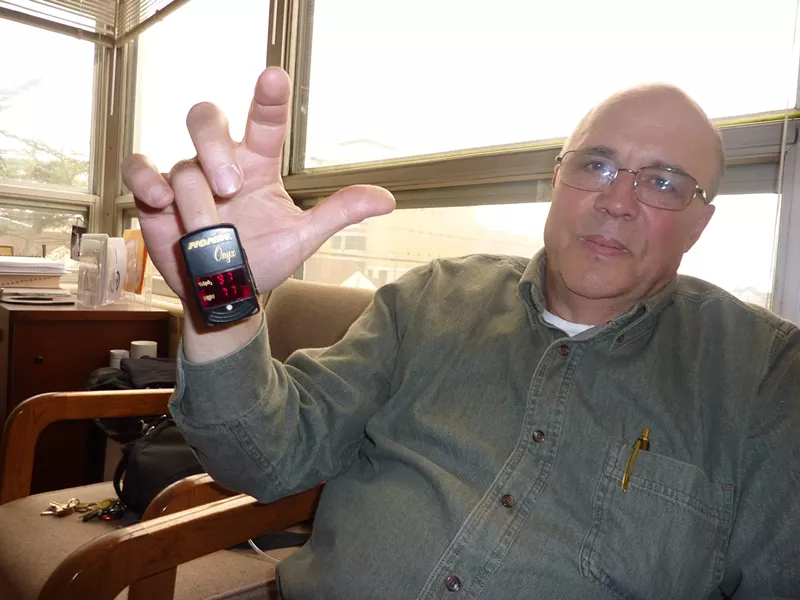 Lance Madsen displays his oximeter, which measures his pulse and blood oxygen. - PHOTO BY RYAN BURNS