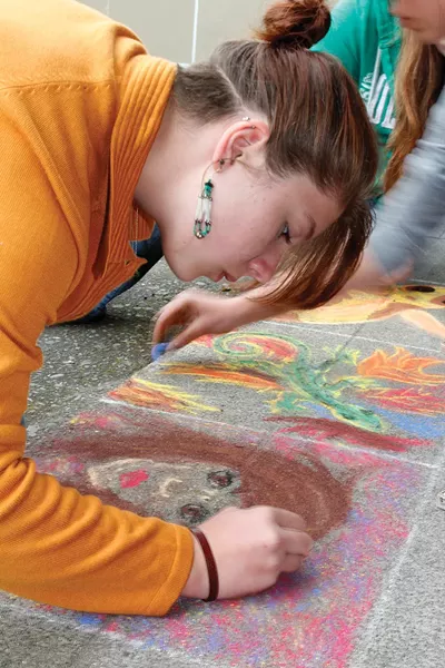 McKinleyville High School student Wendy Witte creates one of the pastel drawings on the school quad. Materials will be supplied for people who want to add their own bit of creativity during McKinleyville’s arts night. - PHOTO COURTESY MCKINLEYVILLE ARTS NIGHT.
