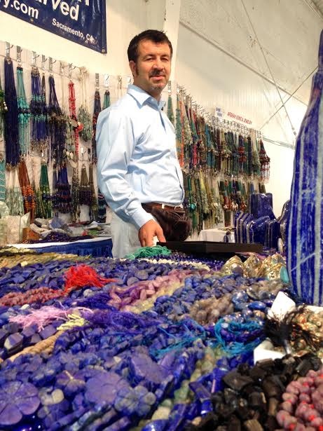 Aman khan Zadran, of Afghan Gem Jewelry, at the Gem Faire in Eureka Saturday. - PHOTO BY HEIDI WALTERS