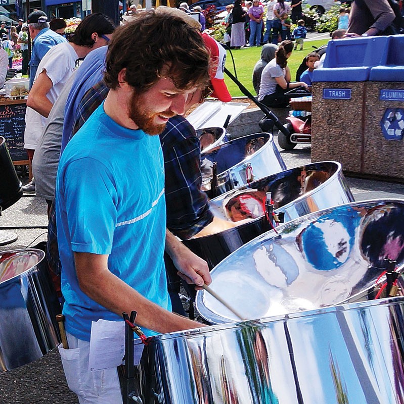 Riley Kennedy-Keys shines in the front line of the rhythmic pan band&nbsp;Steel Standing,&nbsp;providing a soundtrack for the Arcata Farmers Market&nbsp;Saturday, June 21. - PHOTO BY BOB DORAN