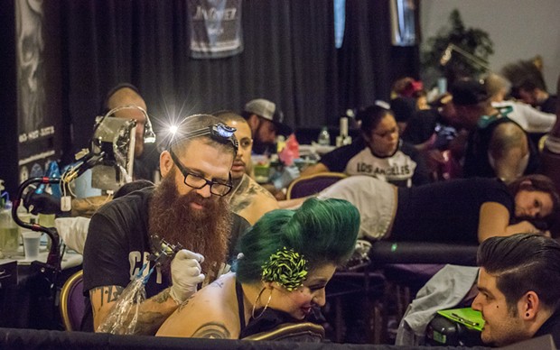 Tattoo artists and the recipients of their work crowded the booths at the Inked Hearts Tattoo Expo. - MARK LARSON