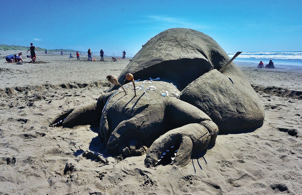 The fanciful "Crab Apple" by the Monsando team earned Best of Show with an unlikely cross-species mutation and a commentary on GMOs at Friends of the Dunes' 19th annual Sand Sculpture Festival at the Manila Dunes Recreation Area on Saturday, June 21. - PHOTO BY BOB DORAN