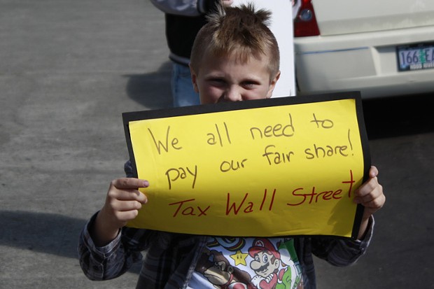 Truth Jackson, 9, of Eureka holds a sign outside the courthouse on Saturday. He goes to Washington Elementary School, and was attending the protest with his mom. - PHOTO BY ZACH ST. GEORGE