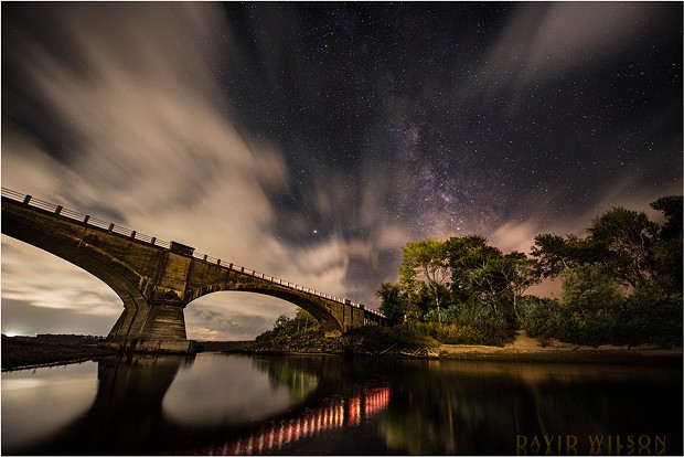 Historic Fernbridge sits out in the cosmos beneath a layer of sweeping clouds and the majestic Milky Way. Mars is bright at center. The lights from passing cars illuminated the shore and provided the reflections. Sept. 11, 2018. - DAVID WILSON