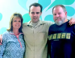 Jeffrey Jurgens at Atascadero State Hospital a couple of years ago, surrounded by his parents. - FAMILY PHOTO VIA JOANNA JURGENS