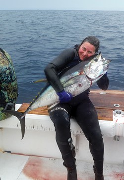 Brandi Easter and her freshly speared yellowfin tuna in Panama in April of 2017. - COURTESY OF BRANDI EASTER