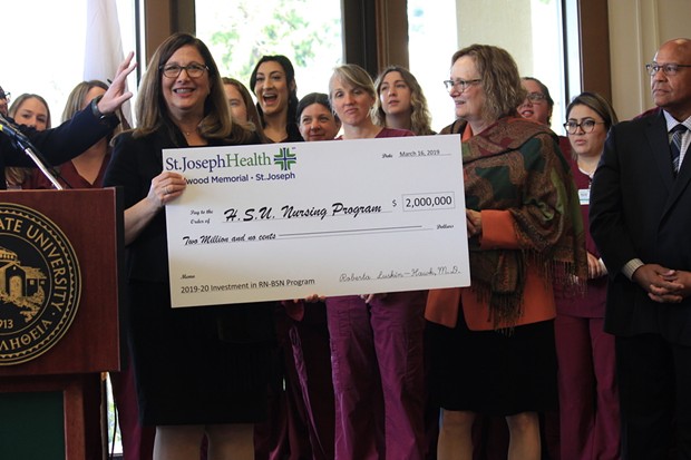 Humboldt State University President Lisa Rossbacher (right) receives a $2 million check from St. Joseph Hospital for the university's new nursing program. - FREDDY BREWSTER
