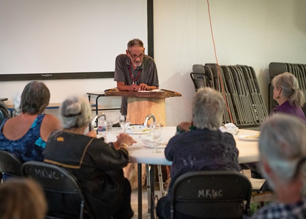 Brian Tripp reads poems before picking up his square drum. - PHOTO BY ZACH LATHOURIS