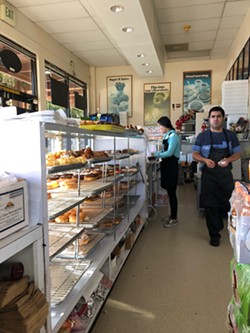 Doing a brisk business at Happy Donuts. - PHOTO BY JENNIFER FUMIKO CAHILL
