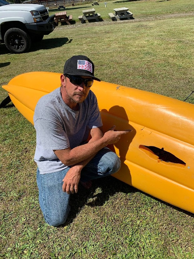 Michael Thallheimer, Jr. and the kayak that was bitten by the shark.