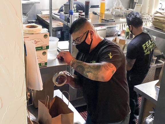 Edson Romero, 34, works as a server at Sage Bistro. His family’s income is about 10 percent of what it was pre-pandemic. - NIGEL DUARA FOR CALMATTERS