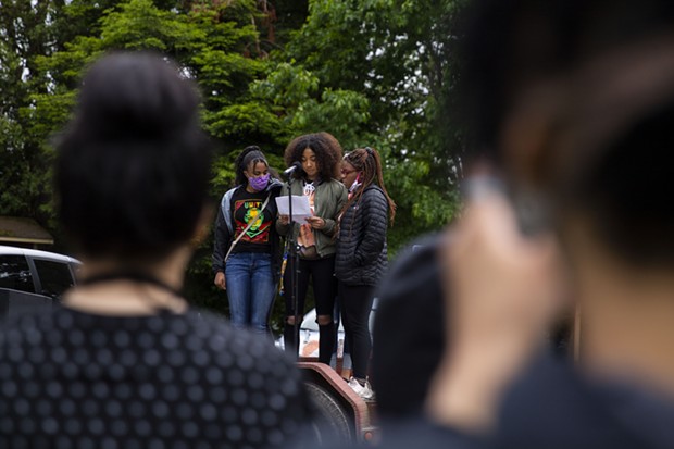 Ayana Watson (left) and her sister Amaya Watson (right) provide suuport for fellow Eureka High School student Sophia Chalmers as she delivers a speech at a demonstration at Rohner Park in Fortuna against racism in June 5. - THOMAS LAL