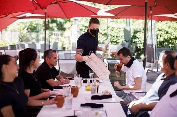Cleverson Davis, a waiter at Palermo Italian Restaurant in San Jose, tends to customers on June 5, 2020. Outdoor parts of restaurants can remain open in the state’s 19 “watch list” counties. - PHOTO BY DAI SUGANO, BAY AREA NEWS GROUP