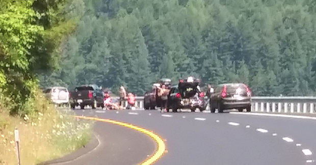 People tend to the injured motorcyclist. [Photo provided by Mark Nelson V]