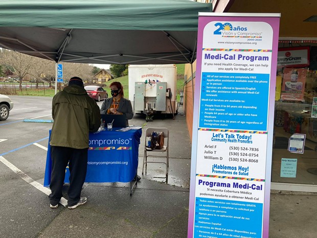 Ariel Fishkin, Visión y Compromiso community promotor, helping someone apply for Medi-Cal while outreaching. - SUBMITTED
