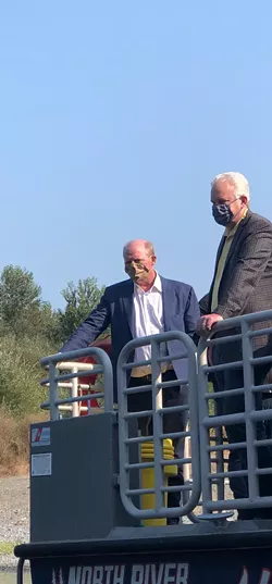 Berkshire Hathaway executives talk to Klamath Justice Coalition activists who stopped them on a trip to the river. - MAHLIJA FLORENDO