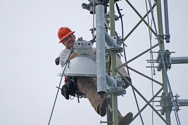 Yurok Connect Coordinator Duston Offins installs a new antenna on a tower in Requa during the implementation of the Yurok Connect Broadband Project. - YUROK TRIBE