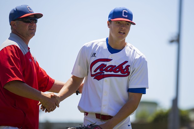 Crabs manager Robin Guiver shakes pitcher Owen Stevenson's hand after Stevenson's last inning of work on July 18, 2021 against the West Coast Kings. - THOMAS LAL
