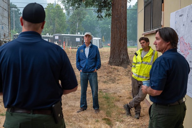 North Coast Congressmember Jared Huffman (center) listens as U.S. Forest Service command staff briefs him on the Monument Fire burning east of Willow Creek. - MARK MCKENNA