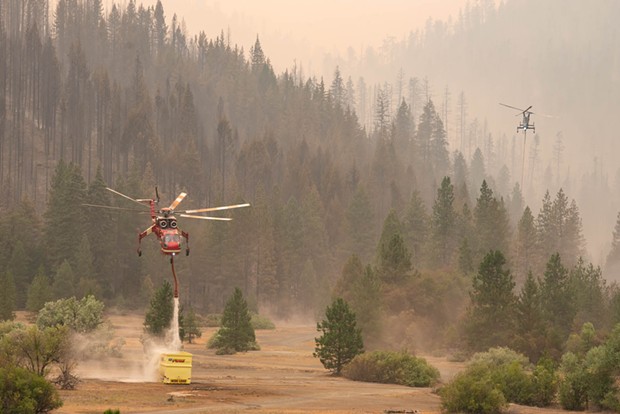 A Sikorsky helicopter refills its tank at a dip point whole working the McFarland Fire. - MARK MCKENNA