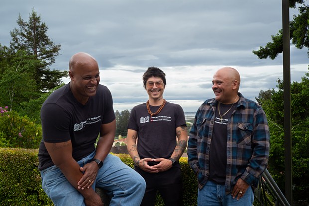 Eric Clark, left, shares a laugh with fellow Project Rebound student Mark Taylor, far right, and program coordinator Tony Wallin. - PHOTO BY DAVE WOODY