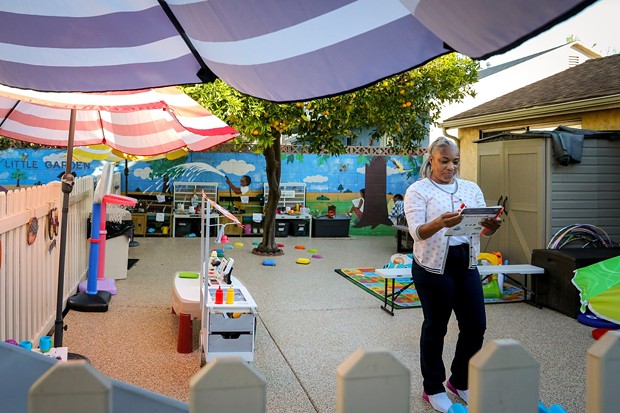 During the early morning, Tonya Muhammad walks through the playground of her child care in Hawthorne, making last inspections before children arrive on Oct. 28, 2021. - PHOTO BY ZAYDEE SANCHEZ FOR CALMATTERS