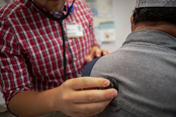 A physician's assistant listens to a patient's heartbeat at a clinic in Bieber on July 23, 2019. - PHOTO BY ANNE WERNIKOFF FOR CALMATTERS