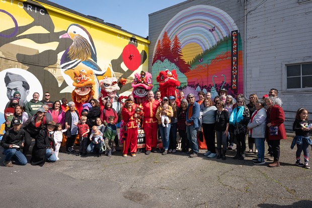 Members of the Eureka Chinatown Project and other supporting community members gather with the Lion Dancers at the dedication and ribbon cutting ceremony for Charlie Moon Way in Eureka. - PHOTO BY DAVE WOODY