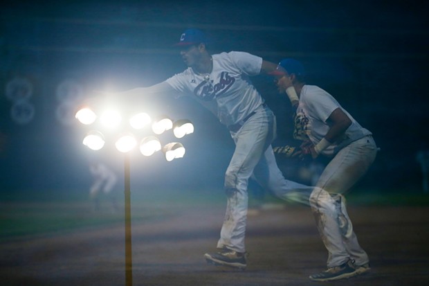 Crabs First Baseman Jordan Petrushka makes a play on a ground ball underneath the stadium lights as the Humboldt Crabs play against the San Luis Obispo Blues on June 10, 2022. Multiple exposures taken in camera. - THOMAS LAL