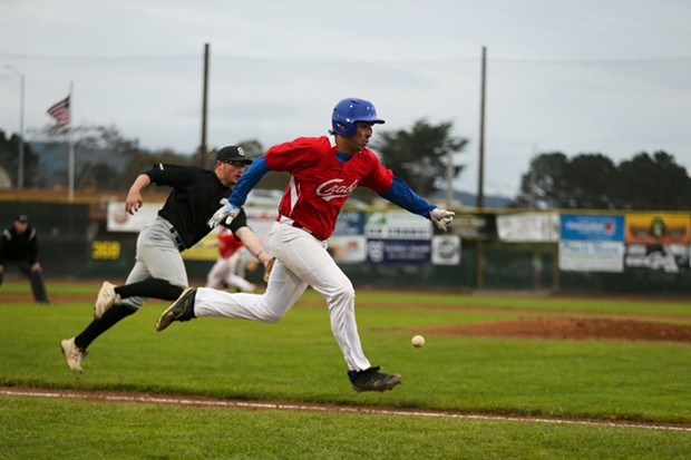 Crabs First Baseman Aaron Perez sprints down the third base line to beat out the fielders on a bunt as the Humboldt Crabs take on the Seattle Studs on June 16. - THOMAS LAL