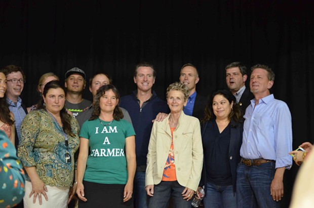 Gavin Newsom (center) poses with Second District Supervisor Estelle Fennell, Congressman Jared Huffman, Assemblyman Jim Wood, Trinity County Supervisor Judy Morris and members of California Cannabis Voice. - GRANT SCOTT-GOFORTH