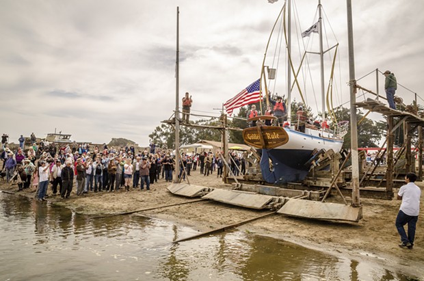 After an opening ceremony, a large crowd gathered on the edge of Humboldt Bay to watch the Golden Rule's launching on Saturday, June 20 at the Zerlang & Zerlang boat yard on the Samoa peninsula. The vessel was then towed by tug to the HSU aquatic center on Eureka's water front for public viewing and a second program about its history. - MARK LARSON
