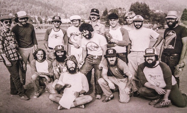 The NEC's softball team, the Snail Darters, in the late 1970s or early 1980s. Dominitz is seated in the front-left with a baseball mitt on his head. - CHRIS JENICAN BERESFORD