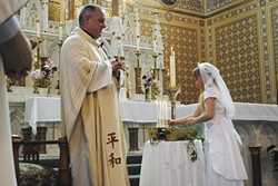 Father Eric Freed at First Communion, 2013 - PHOTO COURTESY OF ST. BERNARD PARISH