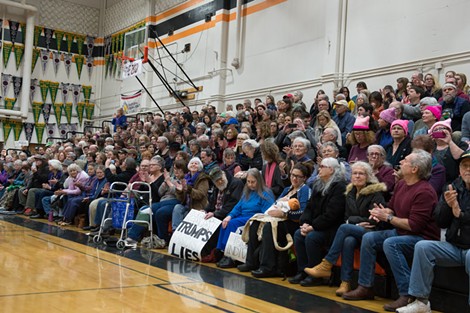 People flocked to Arcata High School, many with signs in hand, Thursday for a town hall meeting with North Coast Congressman Jared Huffman. - BEAU SAUNDERS