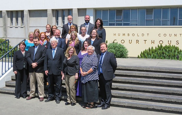 Public Defender staff gathered with now retired Public Defender Kevin Robinson (center).