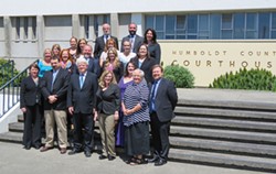 Public Defender staff gathered with now retired Public Defender Kevin Robinson (center).