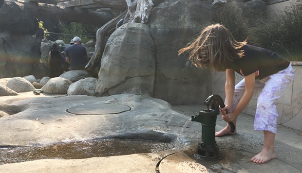 Kids dipped their feet at the zoo to keep cool. - JENNIFER FUMIKO CAHILL