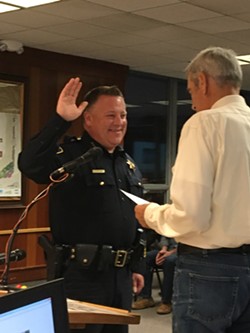 New chief Steve Watson beams as he takes the oath of office. - PAM POWELL