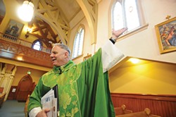 Father Eric Freed during the 125th anniversary Mass at St. Bernard's Church in 2011. - PHOTO BY MARK MCKENNA