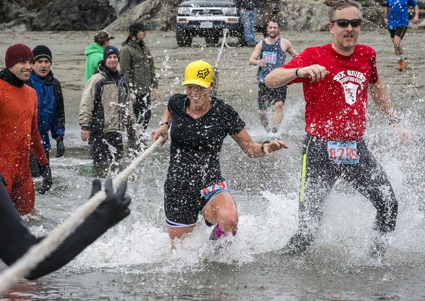 Crystal Mendez (left) and  Chris Schinke raised a splash at the Little River crossing in the 8 3/4-mile race. - PHOTO BY MARK LARSON